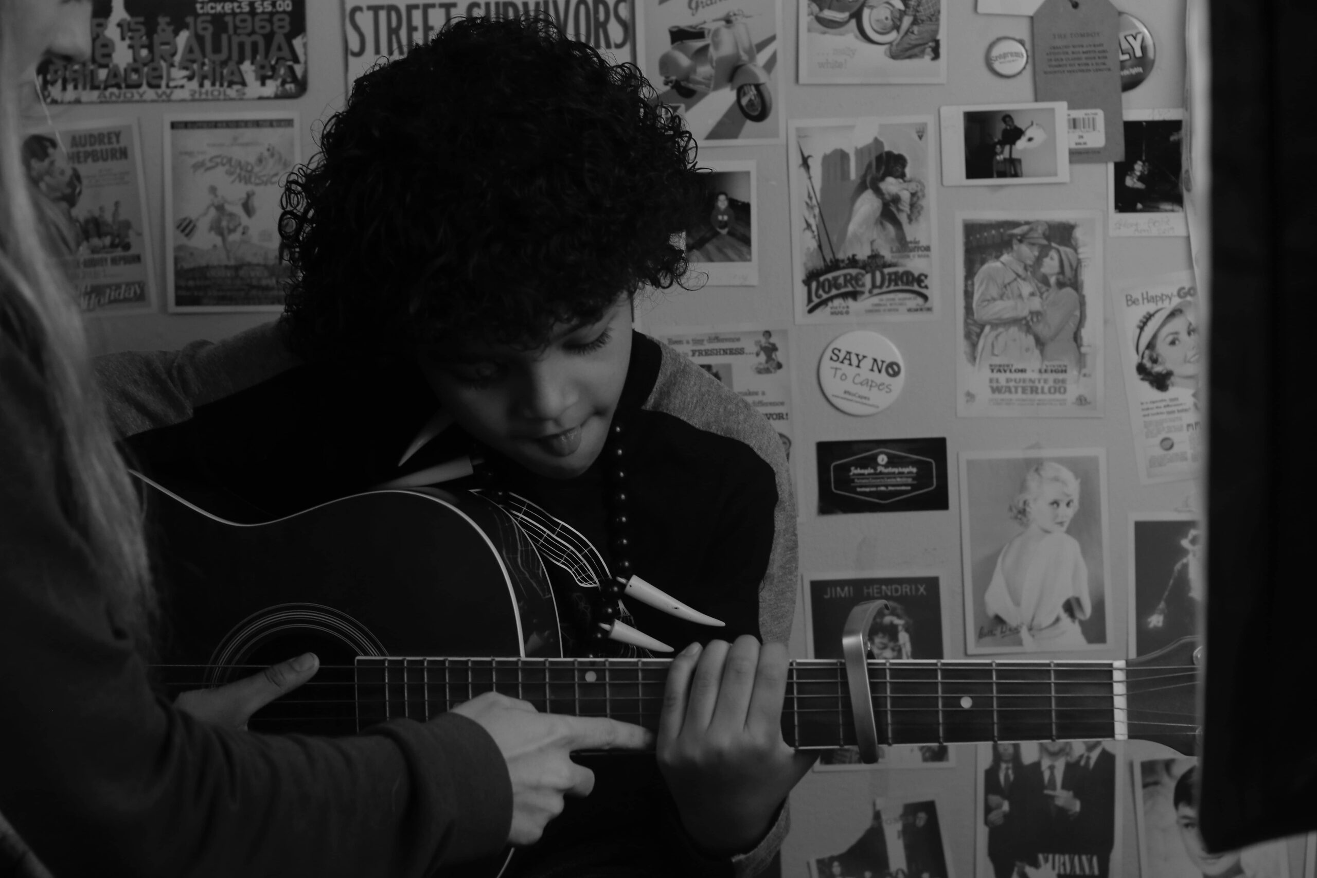 Boy being taught by a guitar teacher