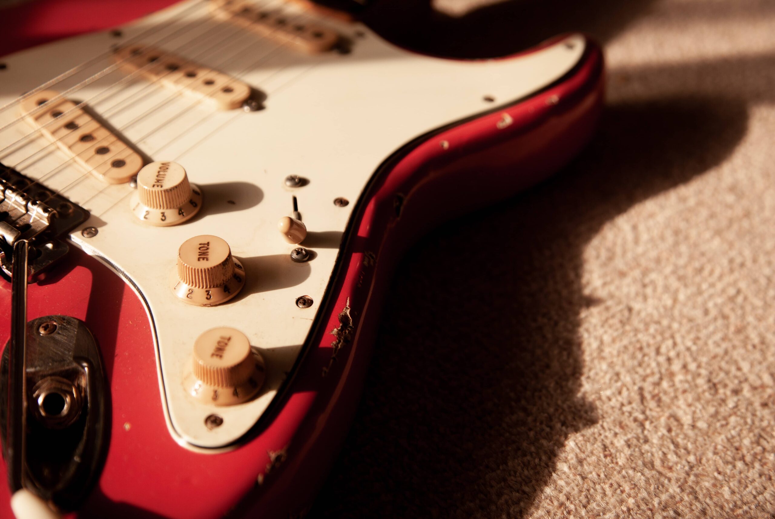 Close up of red electric guitar